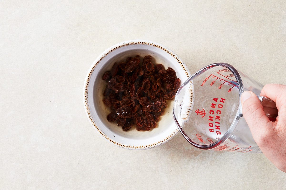 Hermit Cookies Step 1- pouring water over raisins