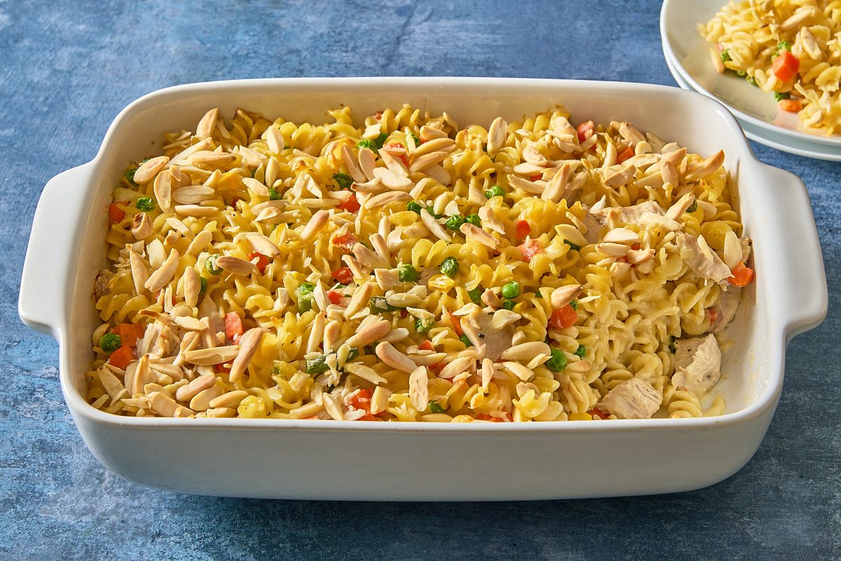 Shot of turkey casserole in a baking dish with a portion scooped out