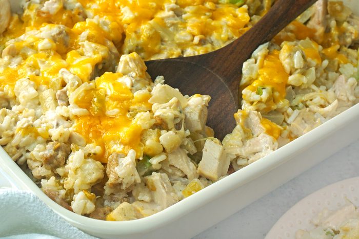 A wooden spoon in a creamy Turkey Rice Casserole by Taste of Home RMS 17968