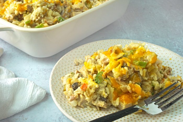 A serving of Turkey Rice Casserole on a plate with a fork by Taste of Home RMS 17968