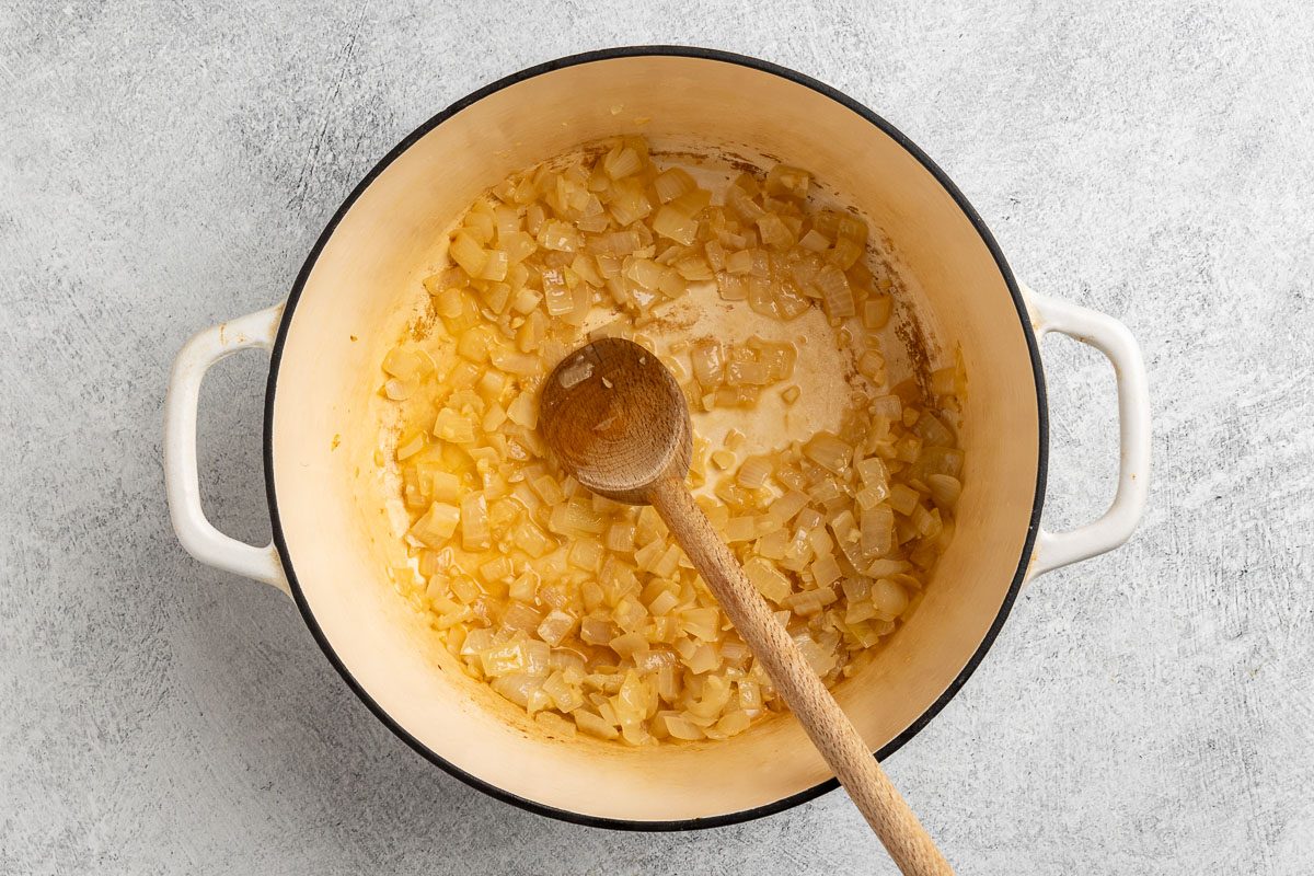 Taste of Home Turnip Soup recipe photo of the sauteed onions, garlic and white wine in a Dutch oven.