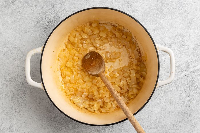 Taste of Home Turnip Soup recipe photo of the sauteed onions, garlic and white wine in a Dutch oven.