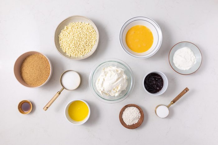 Ingredients for white chocolate raspberry cheesecake on kitchen counter.