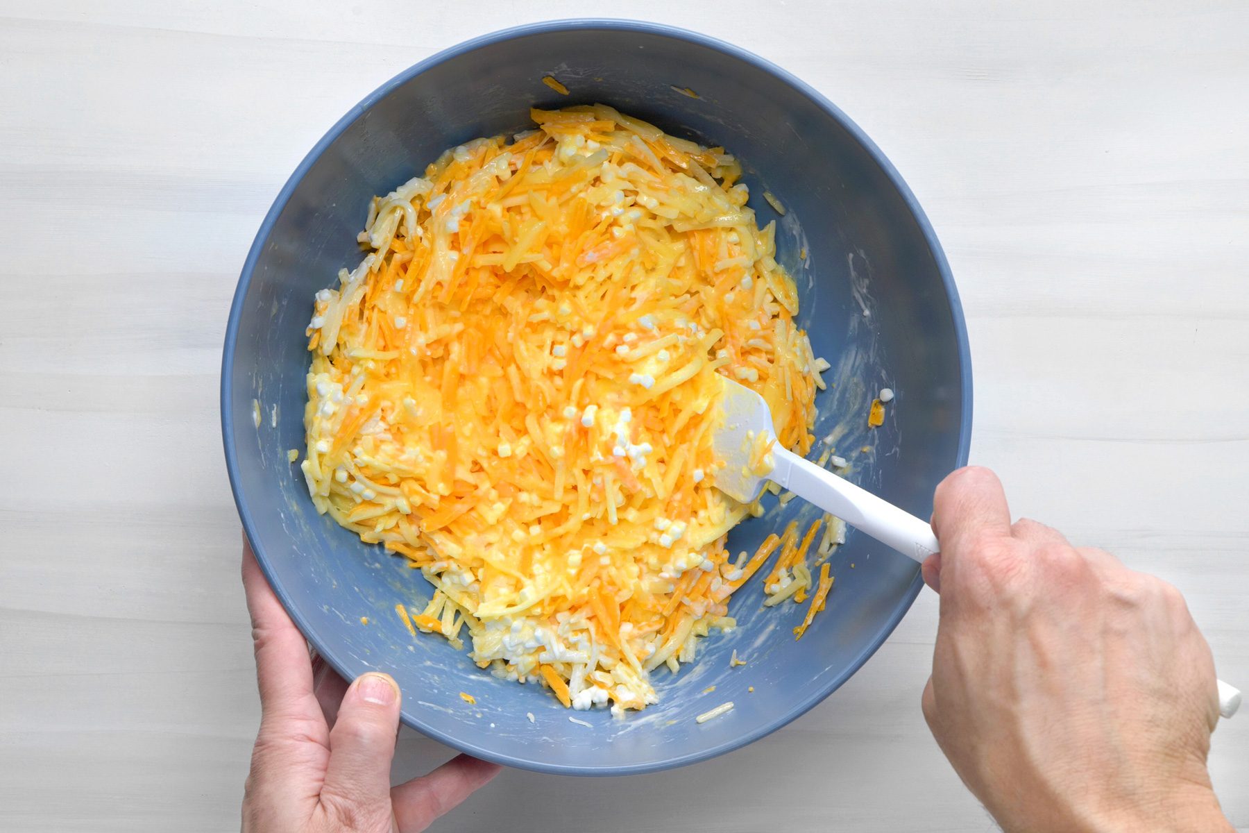 overhead shot; white background; In a large bowl, combining remaining ingredients; stiring in bacon mixture