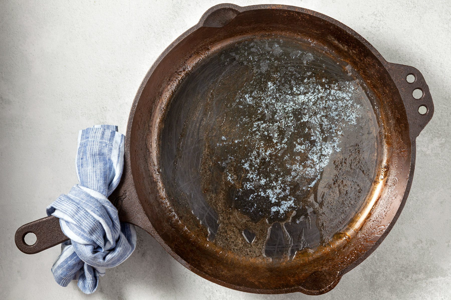 overhead shot; white background; added butter to iron caste pan;