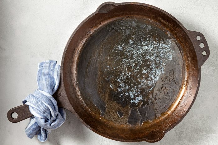 overhead shot; white background; added butter to iron caste pan;
