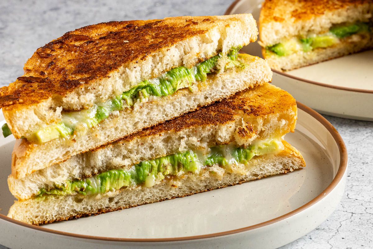 Taste of Home Avocado Grilled Cheese recipe photo of the finished sandwiches cut in half.