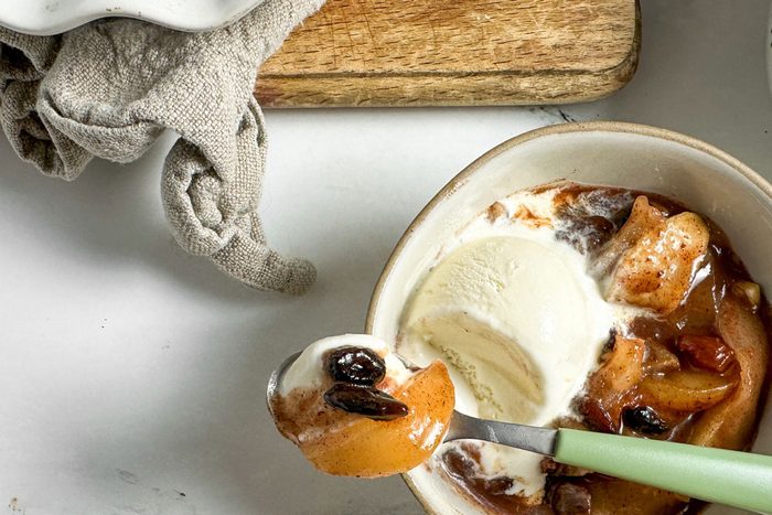 Taste of Home Baked Apple in a ceramic bowl with vanilla ice cream