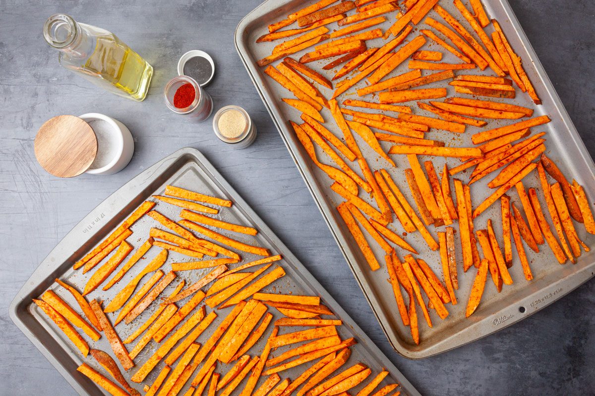 To make Taste of Home Baked Sweet Potato Fries, mix the sweet potatoes, canola oil, garlic powder, paprika, kosher salt and cayenne pepper in a large bowl. Toss the ingredients to ensure the oil and seasonings coat all of the sweet potato strips. Place the sweet potatoes in a single layer on two baking sheets. Bake them for 35 to 40 minutes at 425.