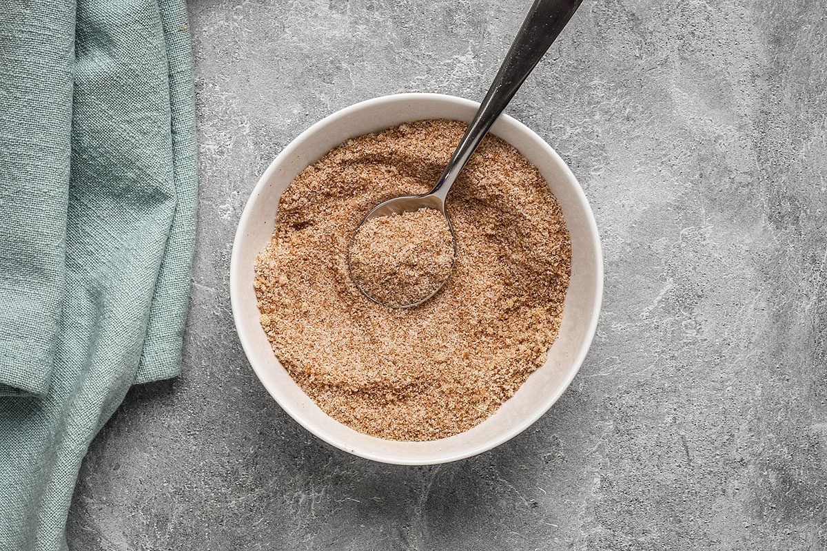 A bowl of cinnamon sugar with granulated and brown sugar, for banana beignets.