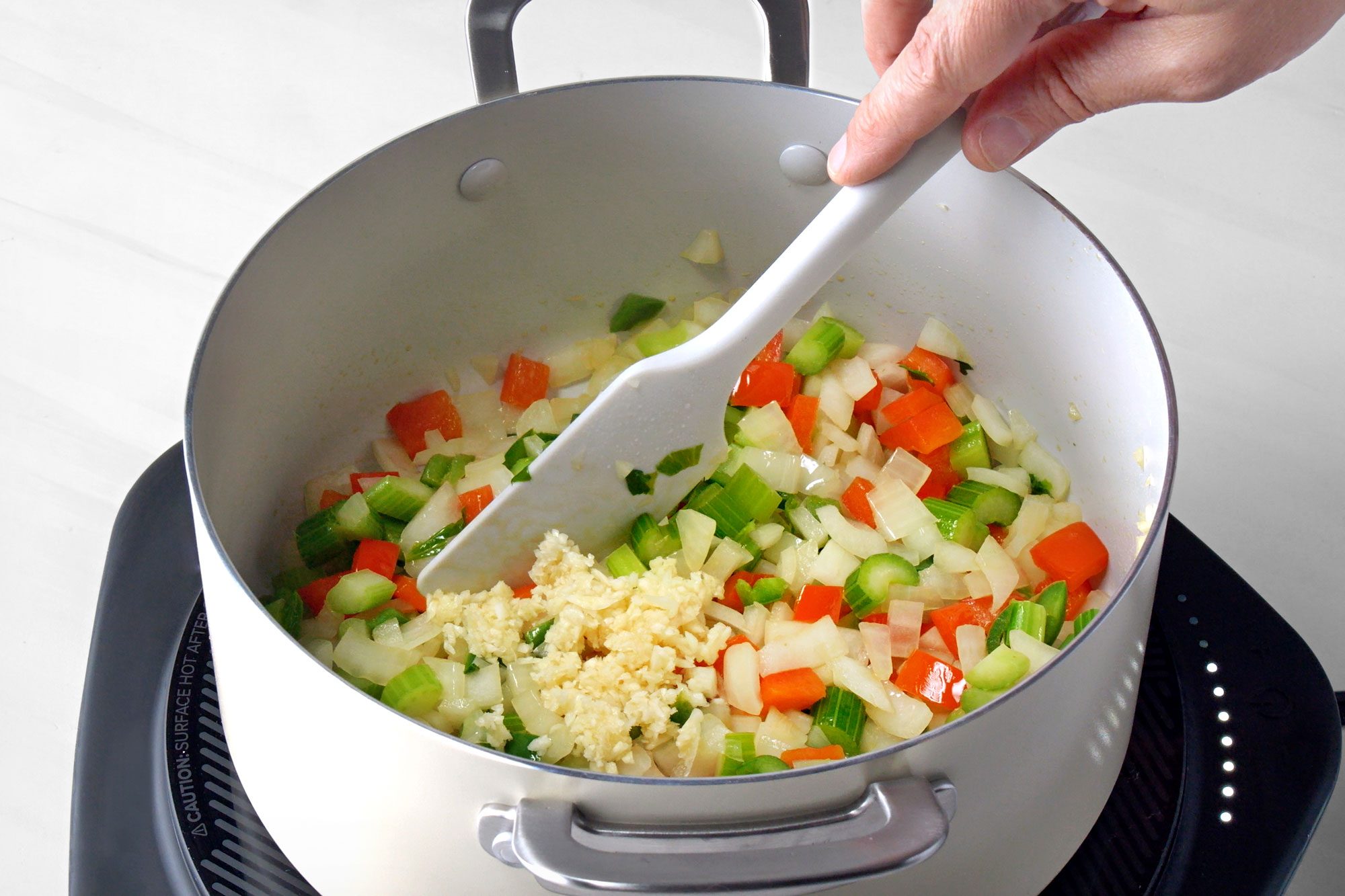 In a large saucepan, saute the celery, onion, red pepper and jalapeno in oil until tender.