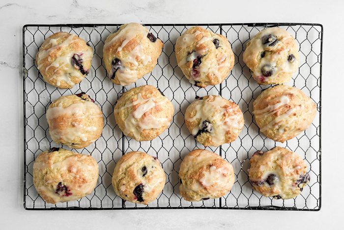 Taste of Home Blueberry Biscuits on a wire rack on a marble surface
