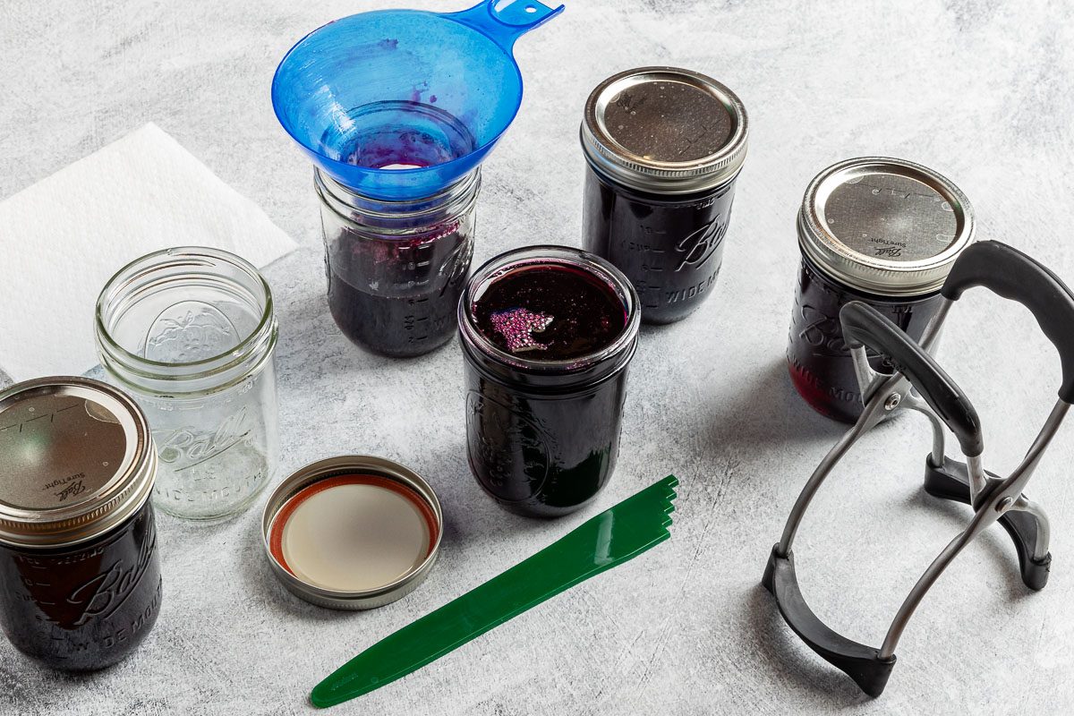 Taste of Home Blueberry Jelly Recipe photo of ladling the jelly into jars.