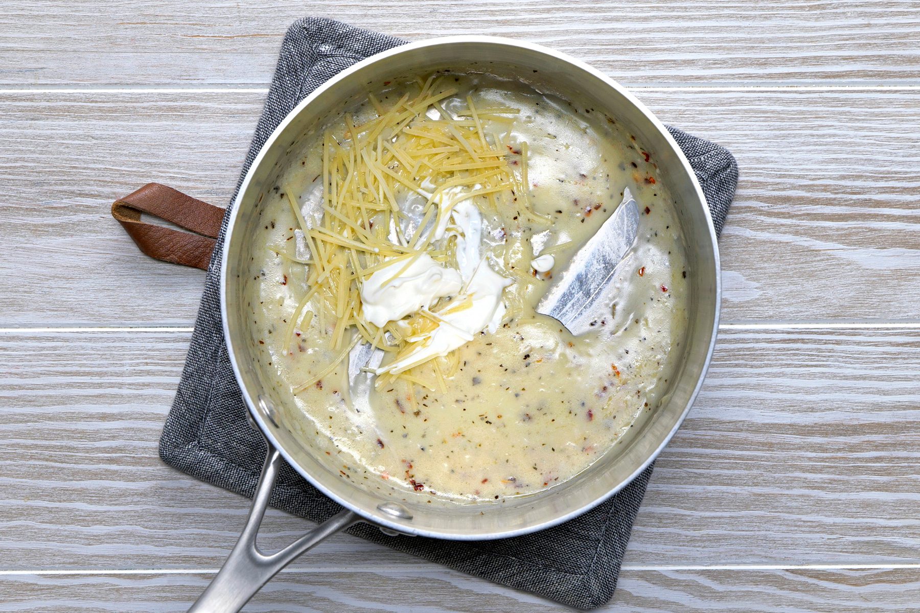 Gradually add the milk, broth and water.