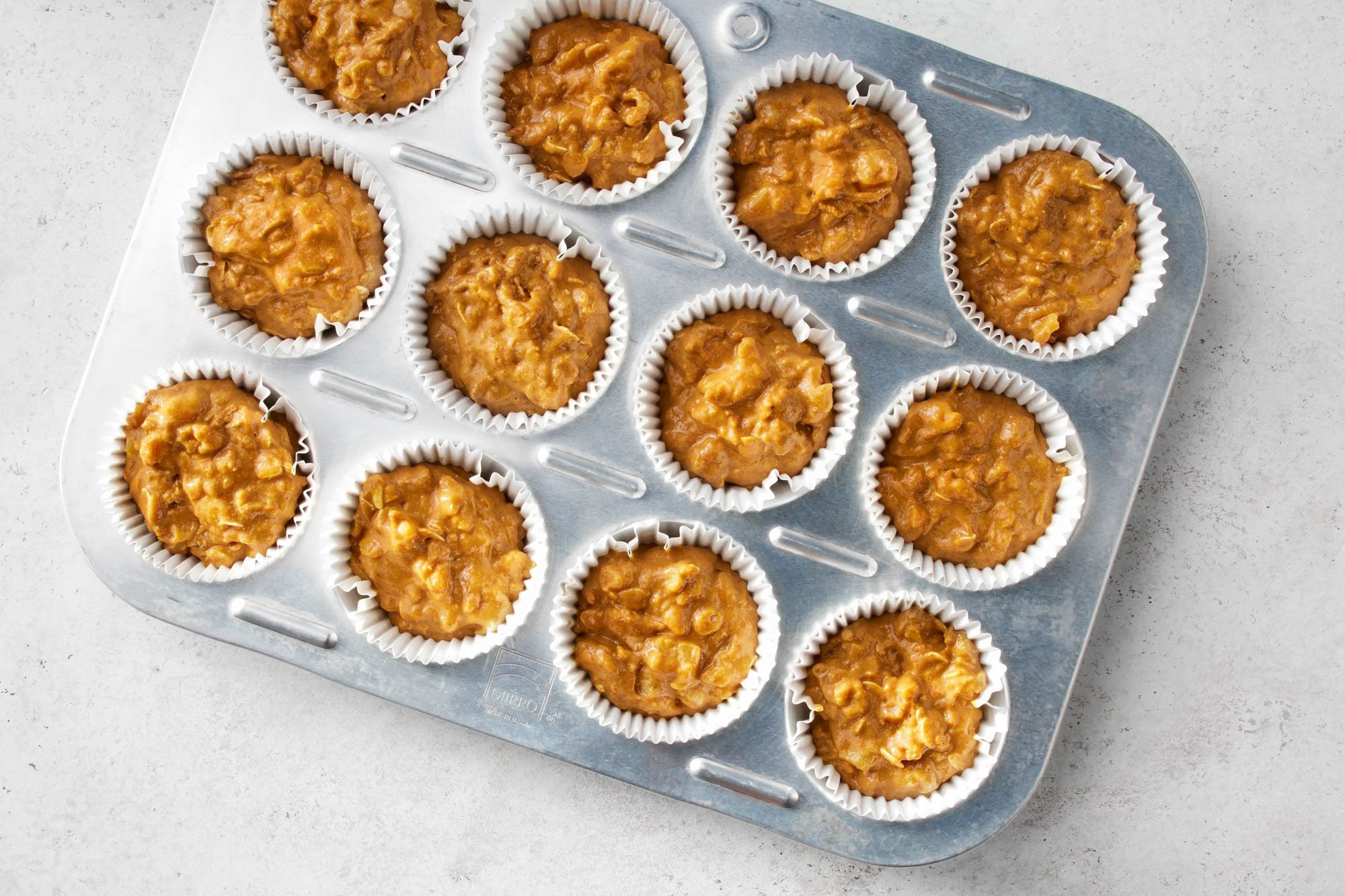 Fill the greased muffin cups two-thirds full.