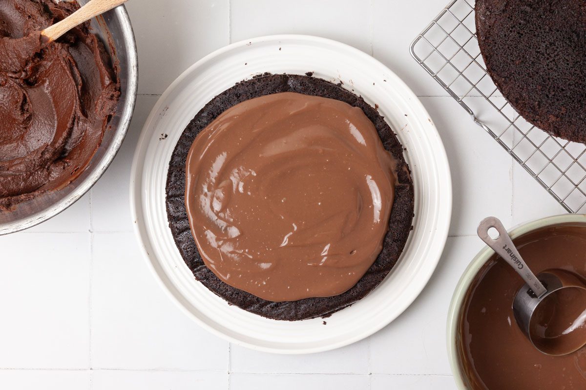 Step 4 of Taste of home Brooklyn Blackout Cake is to Using a long serrated knife, cut each cake horizontally in half. Place a cake layer on a serving plate and spread with half of the pudding. Repeat the layers. Top with a third cake layer. Spread frosting over the top and sides of the cake.