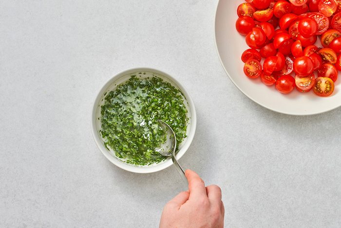 Preparing the vinaigrette in a small bowl