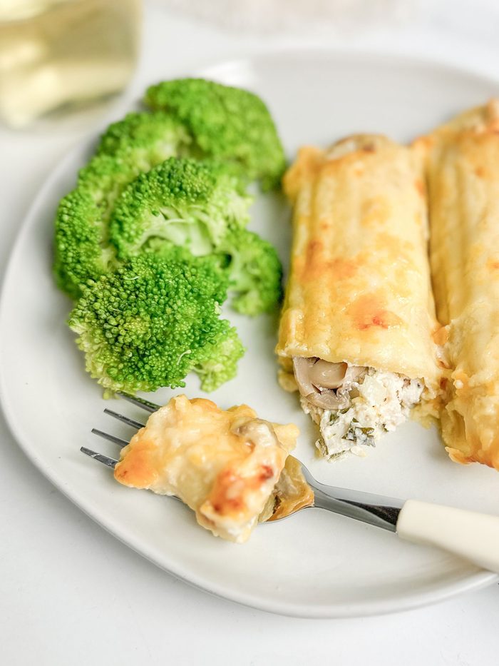 Taste of Home Chicken Manicotti with broccoli on a white plate