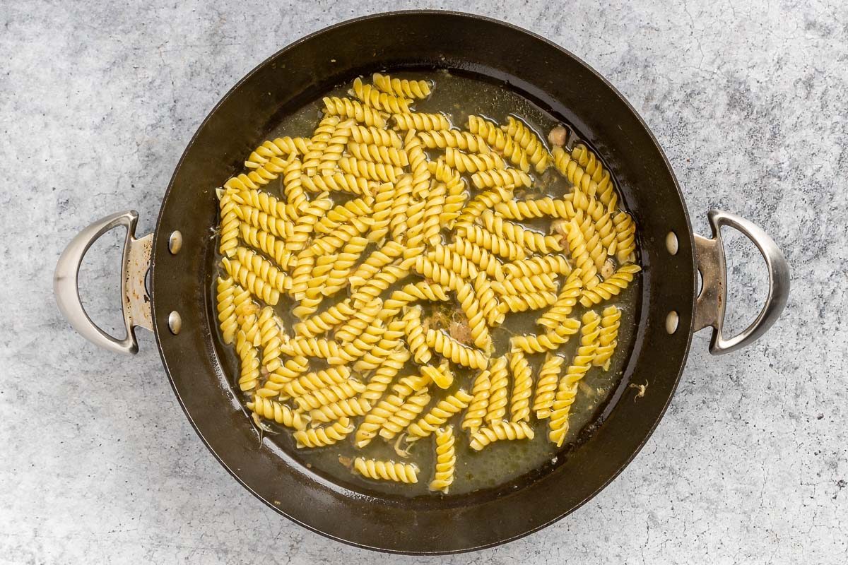 Taste of Home Chicken Pesto Pasta recipe photo of the pasta cooked in chicken broth in the skillet.