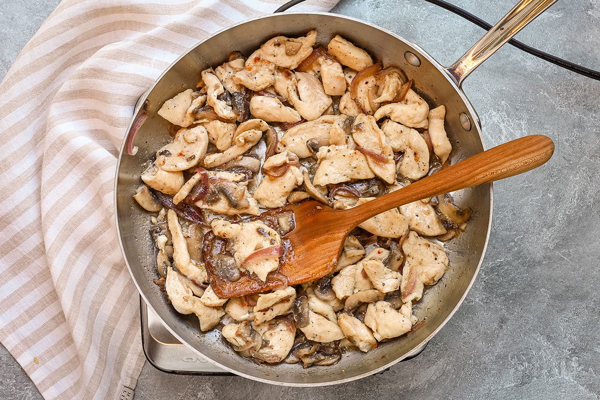 Cooking the chicken and vegetables in a skillet for chicken subs, a recipe from Taste of Home.