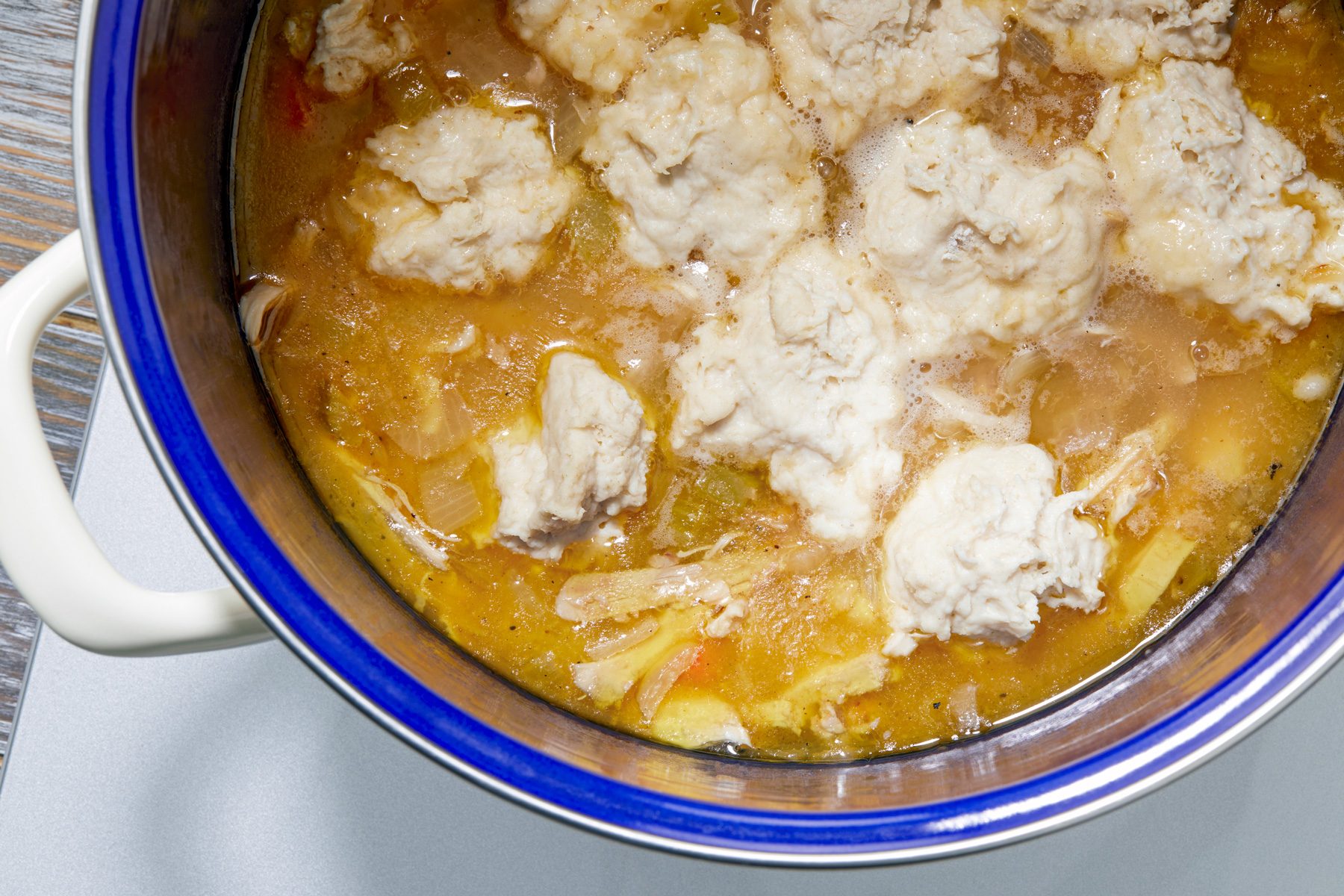 overhead shot; Dropped dumplings on top of simmering soup a few at a time