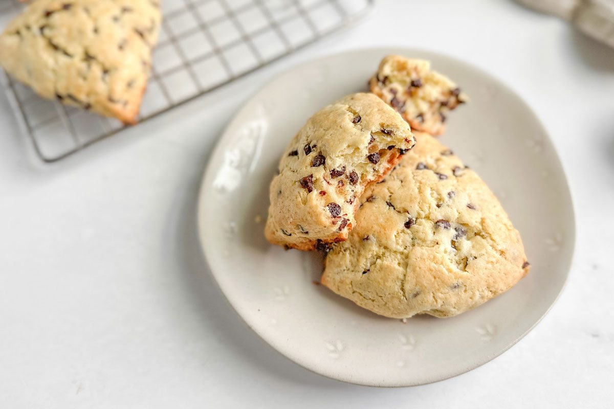 Taste of Home Chocolate Chip Scones on a white plate on a marble surface