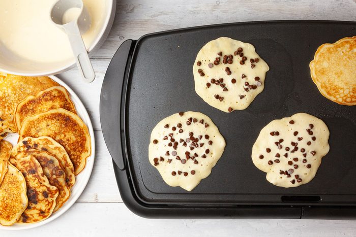 Step 2 of Taste of Home Chocolate Chip Pancakes is to Sprinkle 2 teaspoons of miniature chocolate chips over the tops of the circles of batter. When the tops of those pancakes start to bubble, turn them over and cook until the second side turns golden-brown
