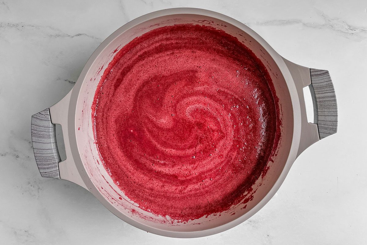 Taste of Home Christmas Jam in a Dutch oven on a marble surface