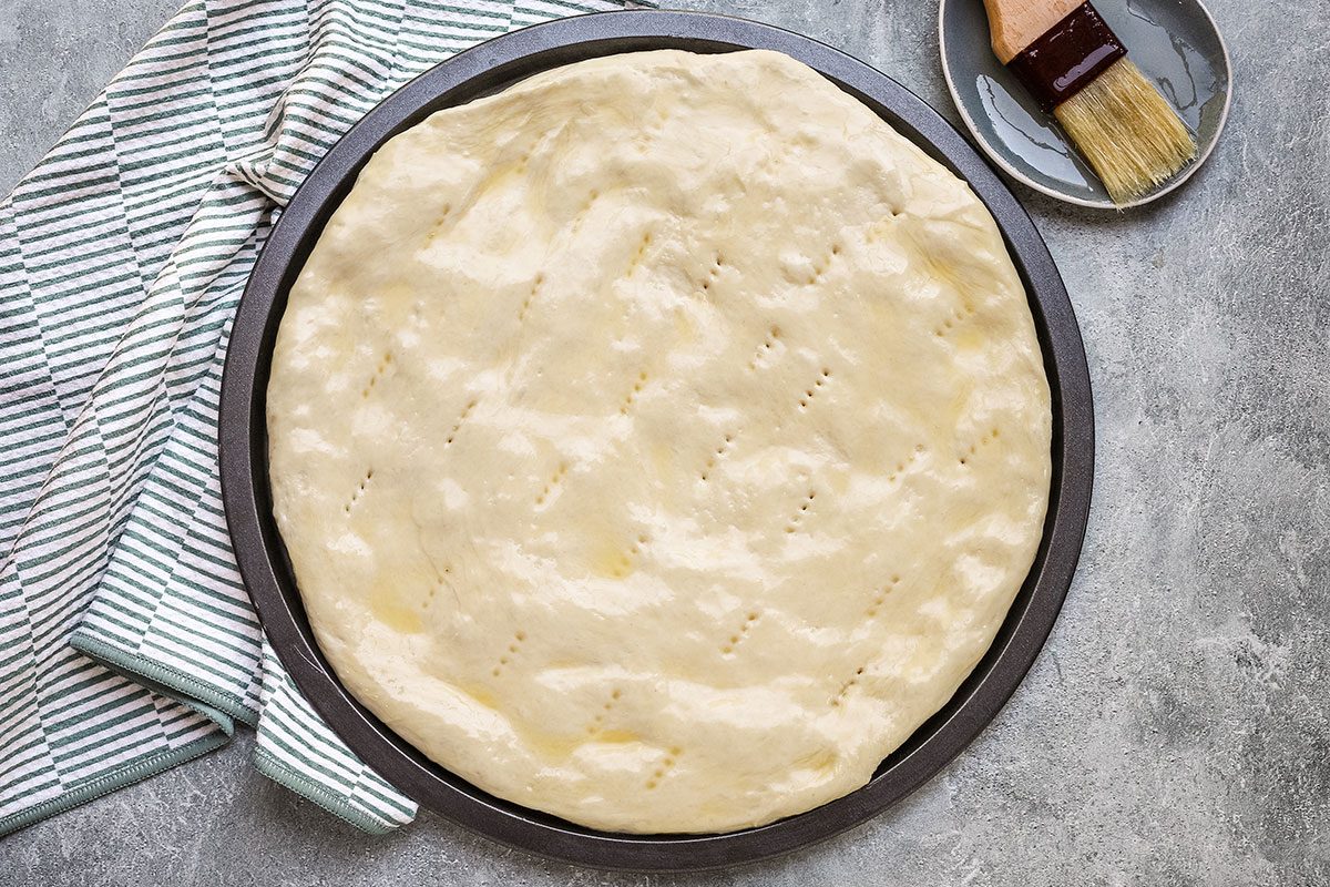 Cinnamon roll focaccia dough in the pan and ready to bake.