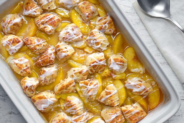 Cinnamon Roll Peach Cobbler served in a serving pan