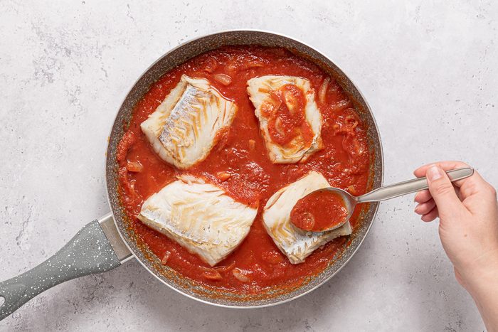 Pan With Tomato Sauce And Cod Fillets