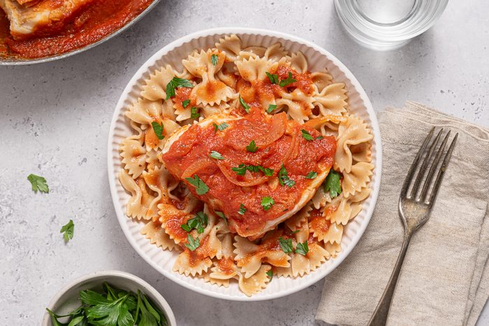 Plate With Whole Wheat Past And Cod In Tomato Sauce And Parsley
