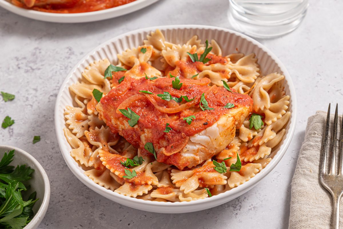 Plate With Whole Wheat Past And Cod In Tomato Sauce And Parsley