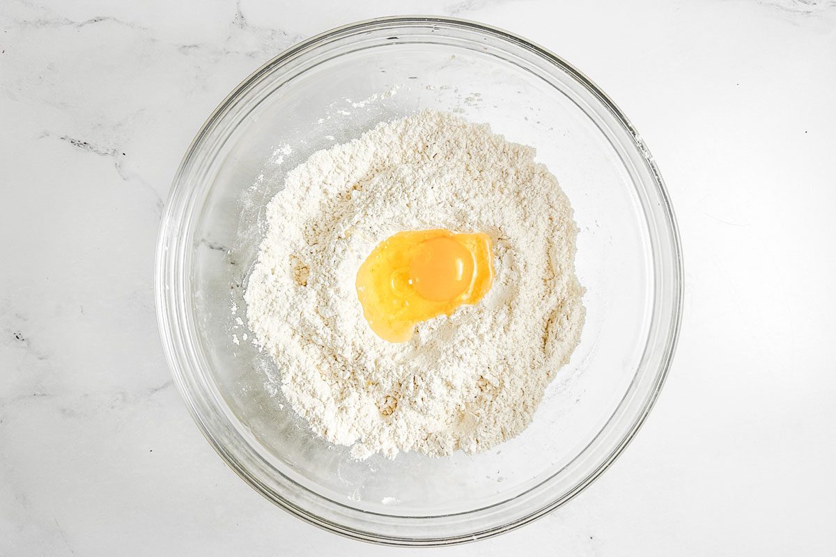 Egg and flour in a glass bowl for Taste of Home Copycat Cracker Barrel Chicken and Dumplings
