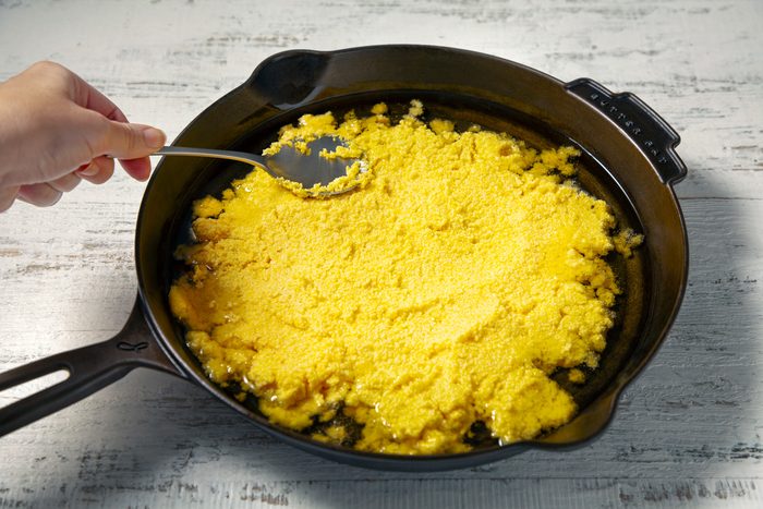 spread mixture evenly in preheated skillet, spooning some of the oil on top of batter.