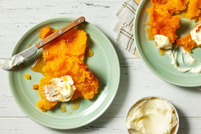 wide shot of corn pone served with butter and honey