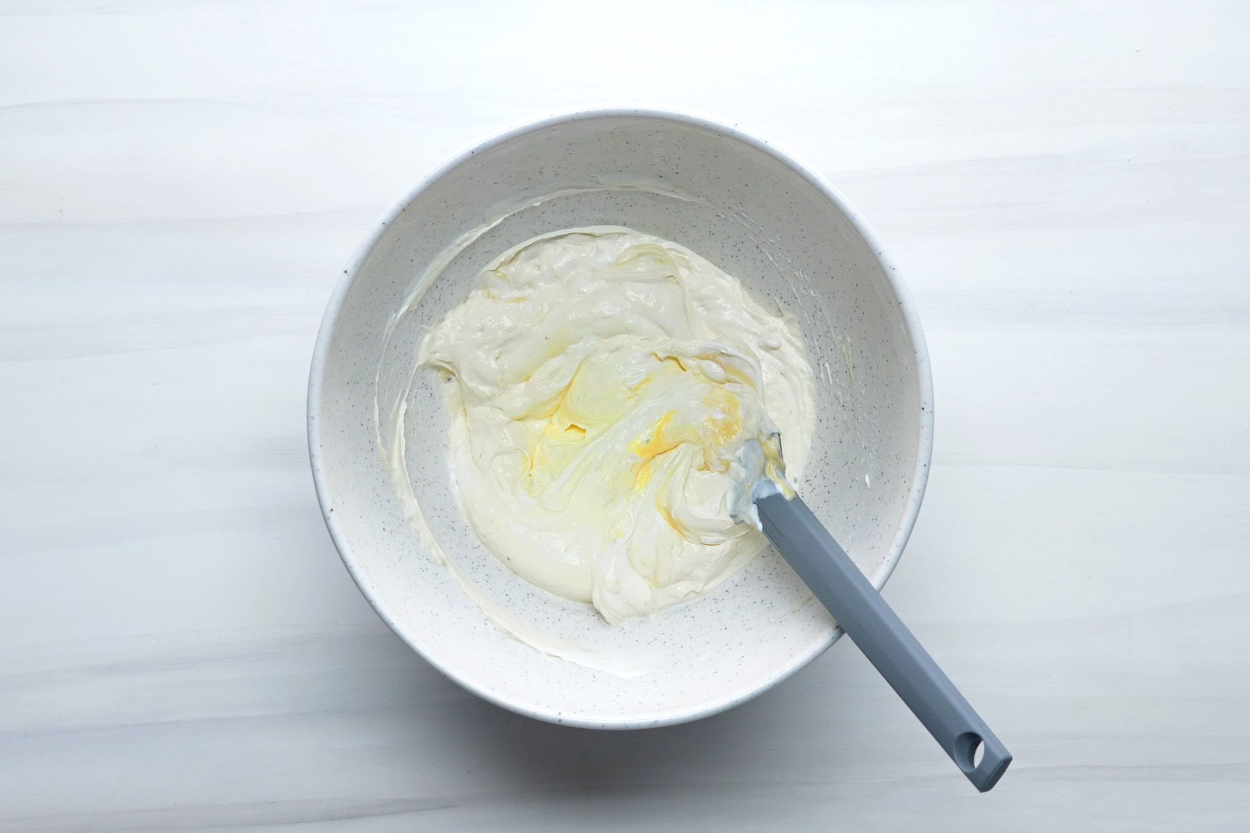 Sour cream, undiluted condensed soup, salt and pepper mixed in a large bowl.