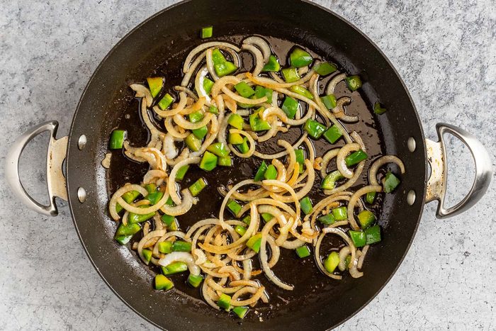 Taste of Home Hawaiian Pork Chops photo of the sauteed onion and green pepper in the skillet.