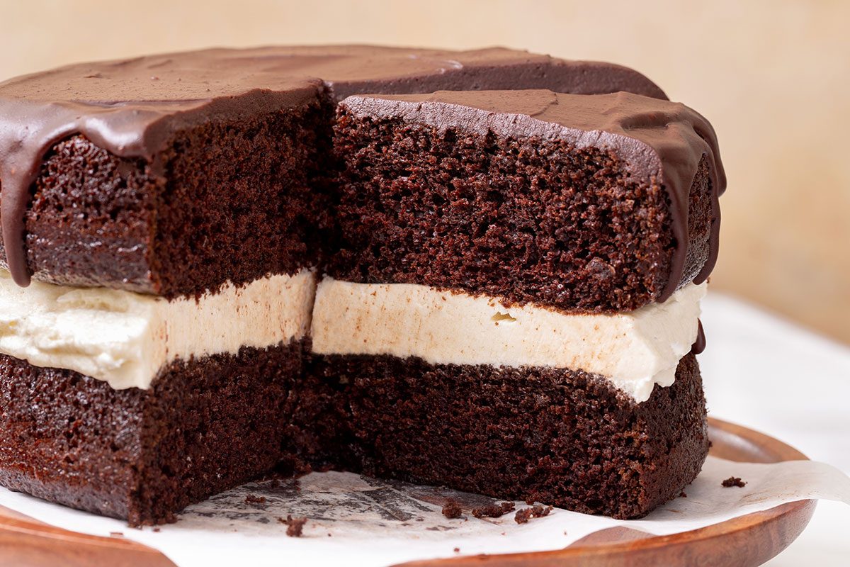 Sliced Ho Ho Cake on a cake stand for Ho Ho Cake recipe for Taste of Home