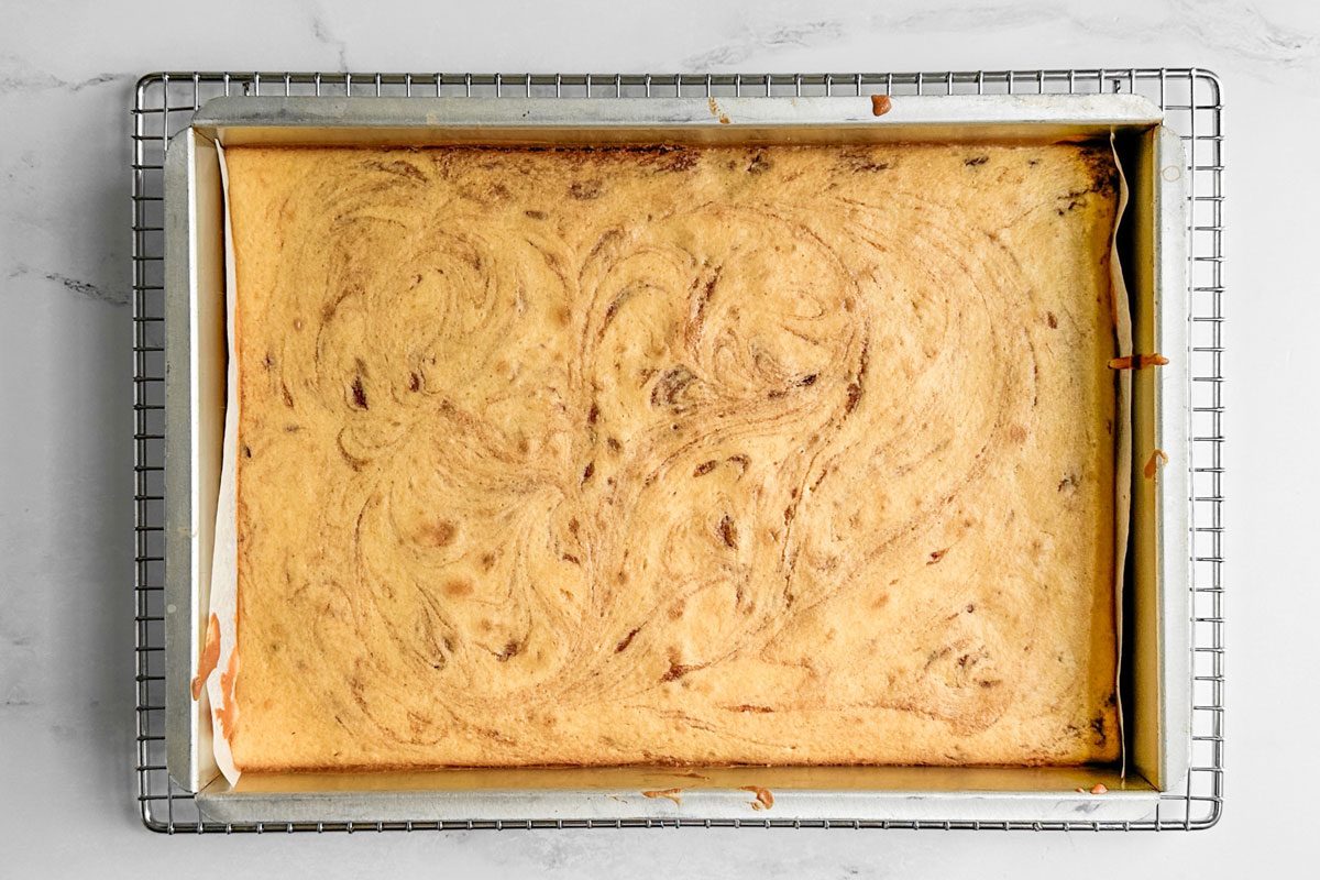 Taste of Home Honey Bun Cake on a wire rack on a marble surface