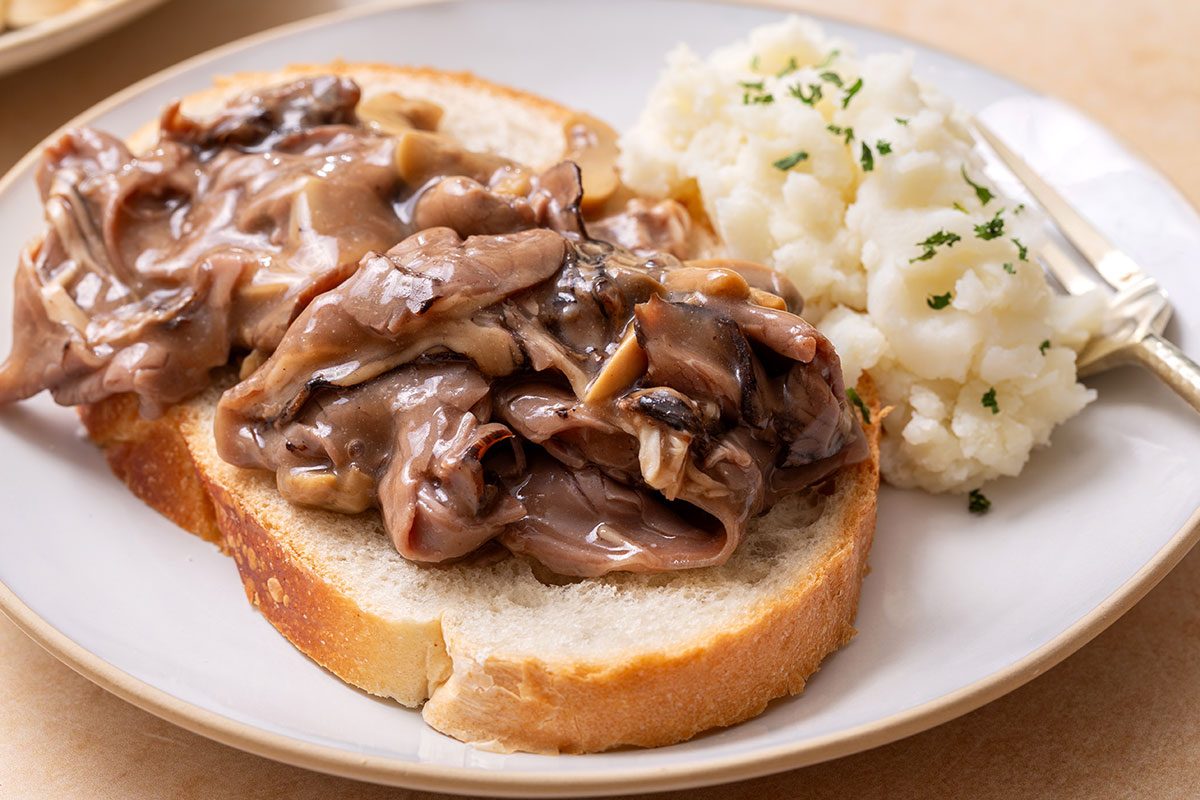 Hot Roast Beef Sandwich on a plate with a side of mashed potatoes for Taste of Home