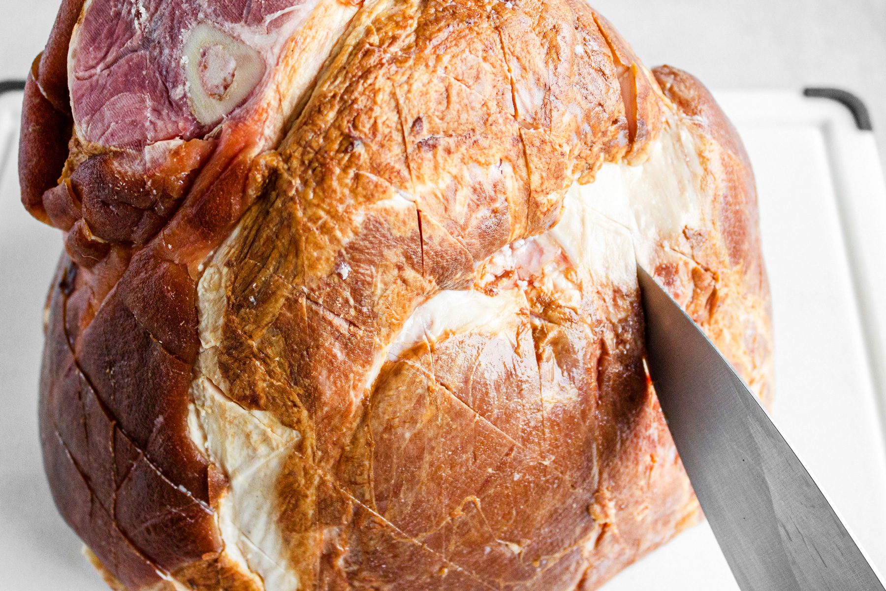 3/4th shot; white background; ham; with knife