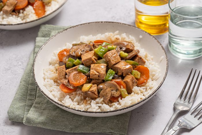 Closeup Of Plate With Rice, Vegetables And Leftover Pork
