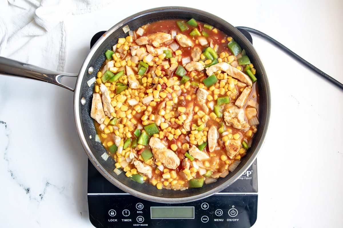 Overhead shot for Taste of Home Mexican Chicken and Rice with all ingredients cooking in a Hexclad.