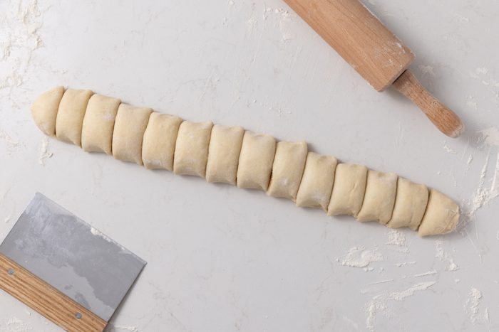 Cinnamon rolls being cut.