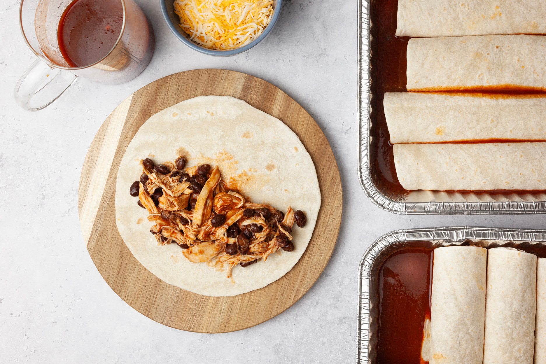 Step 3 of Taste of Home Crock-Pot Chicken Enchiladas is to combine the chicken, enchilada sauce and chiles. Cook, covered, on low for 6 to 8 hours or until the meat is tender. Place about 1/3 cup chicken mixture down the center of each tortilla. Roll up the tortilla around the chicken and place them seam side down in the prepared dishes. Pour the remaining reserved juices over the top and sprinkle with cheese.
