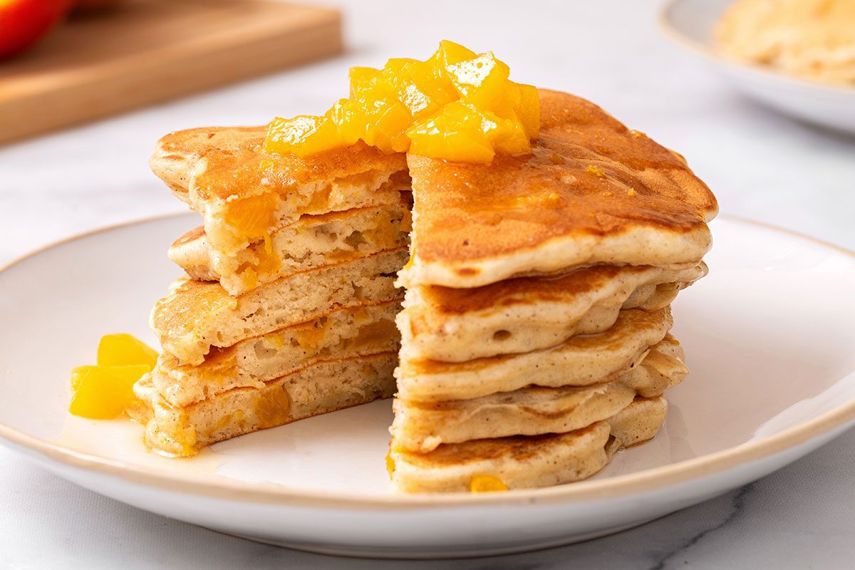 Peach Pancakes on a plate with butter syrup