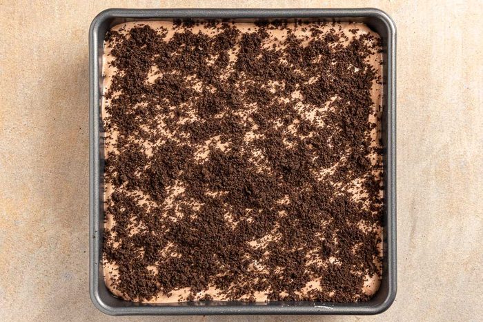 Taste of Home Peanut Butter Lasagna recipe photo of the crushed cookie topping added to the baking dish.