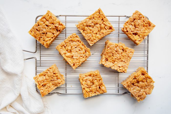 Overhead beauty shot for Taste of Home Peanut Butter Cornflake Cookies cut on a wire rack.
