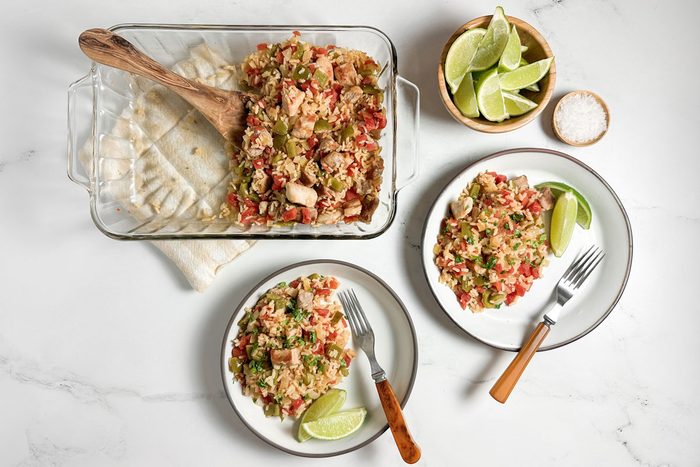Taste of Home Pork and Rice on ceramic plates with bowls of lime wedges and salt
